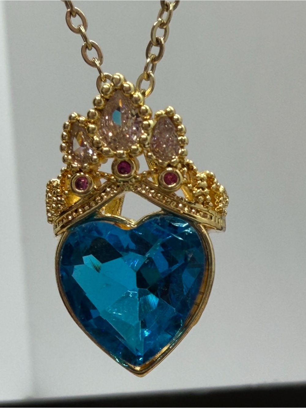 Gold-Tone Crown Heart Necklace with Blue Crystal Pendant